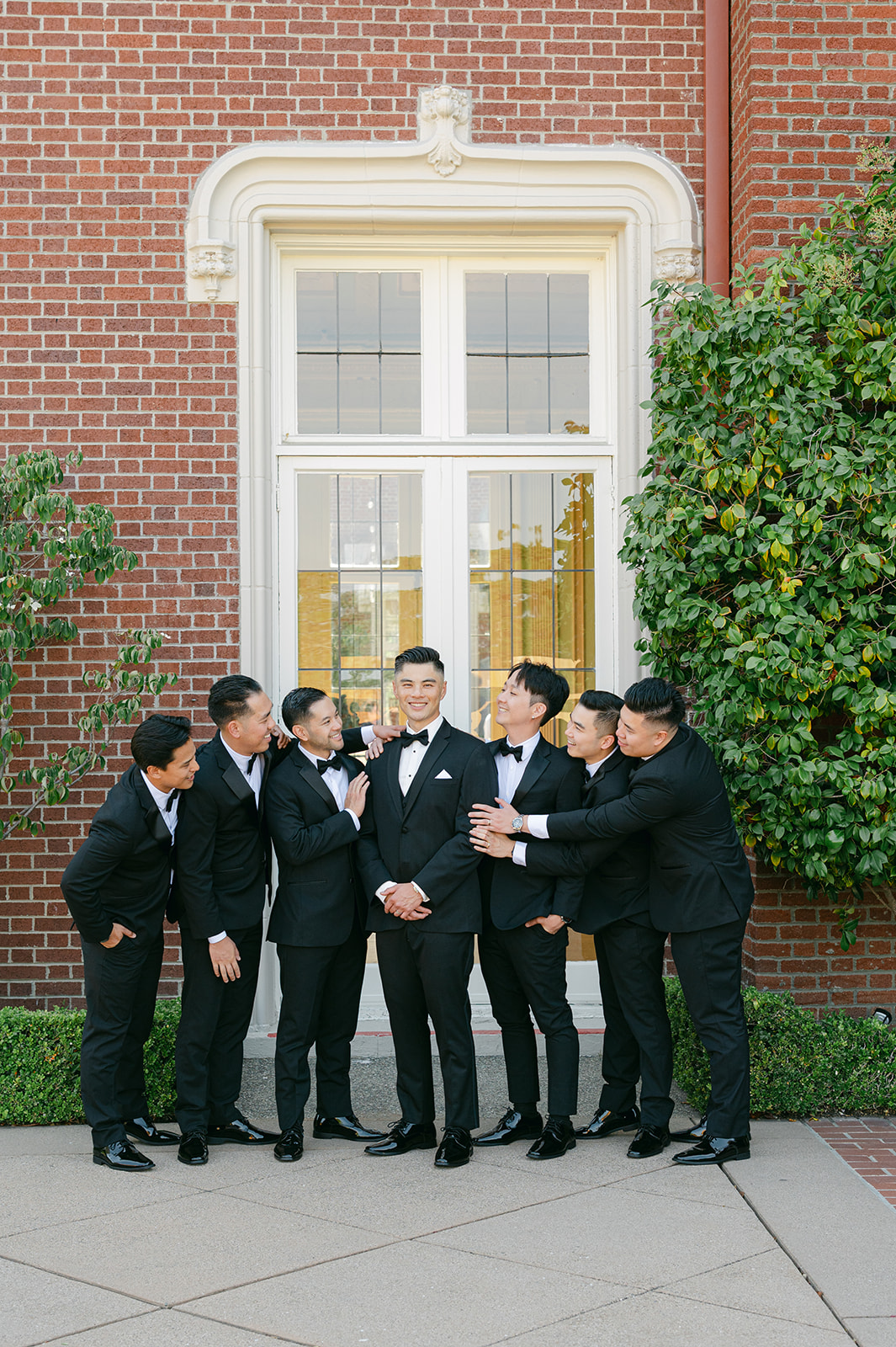 Groomsmen group photo looking at the groom.