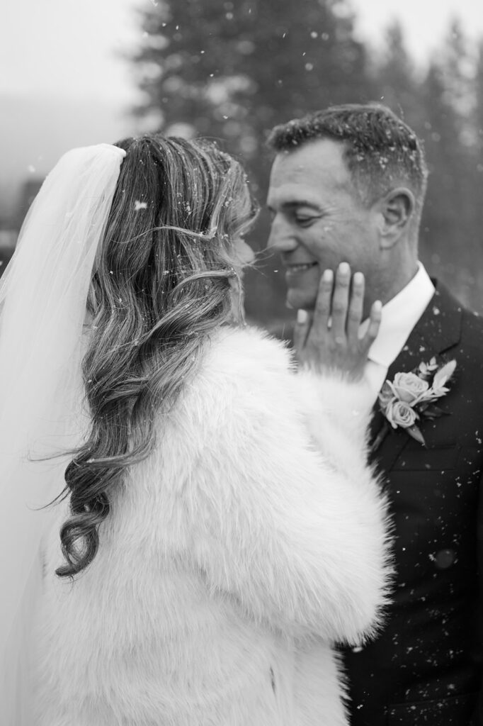 Bride and Groom embrace during snowstorm during their snowy winter elopement in Lake Tahoe.
