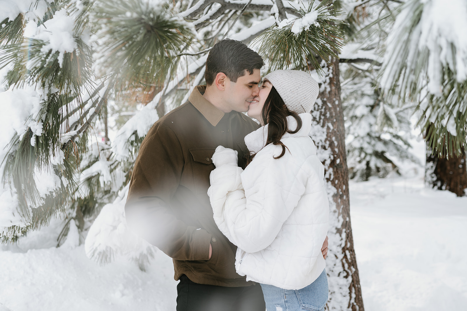 Couple leaning in for a kiss during their winter engagement photos in Lake Tahoe. 