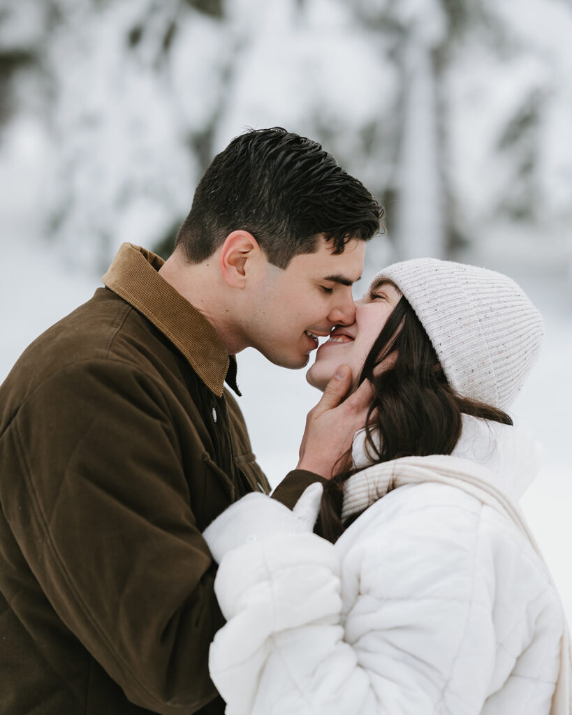 Couple leaning in for a kiss during their winter engagement session. 