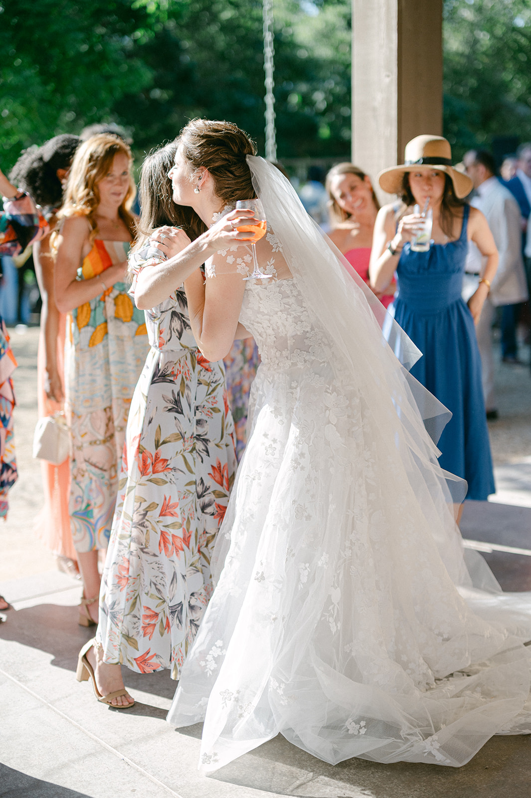 Guests mingling during cocktail hour at vineyard estate.