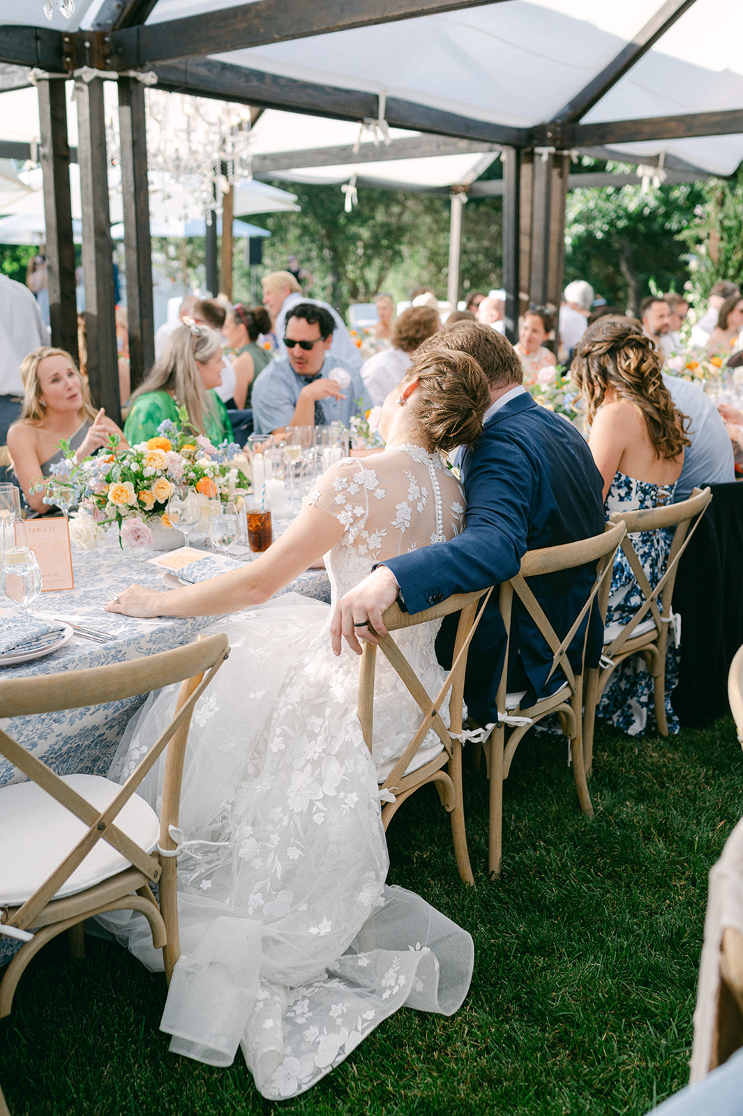 Bride and groom seated together during reception dinner.