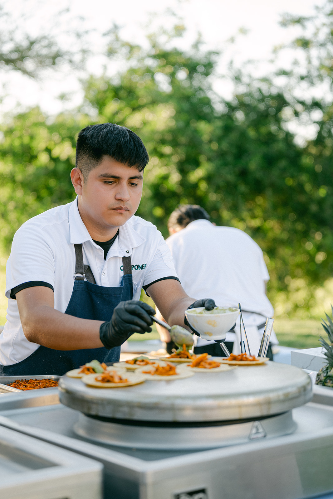 Interactive food stations at outdoor vineyard wedding reception.