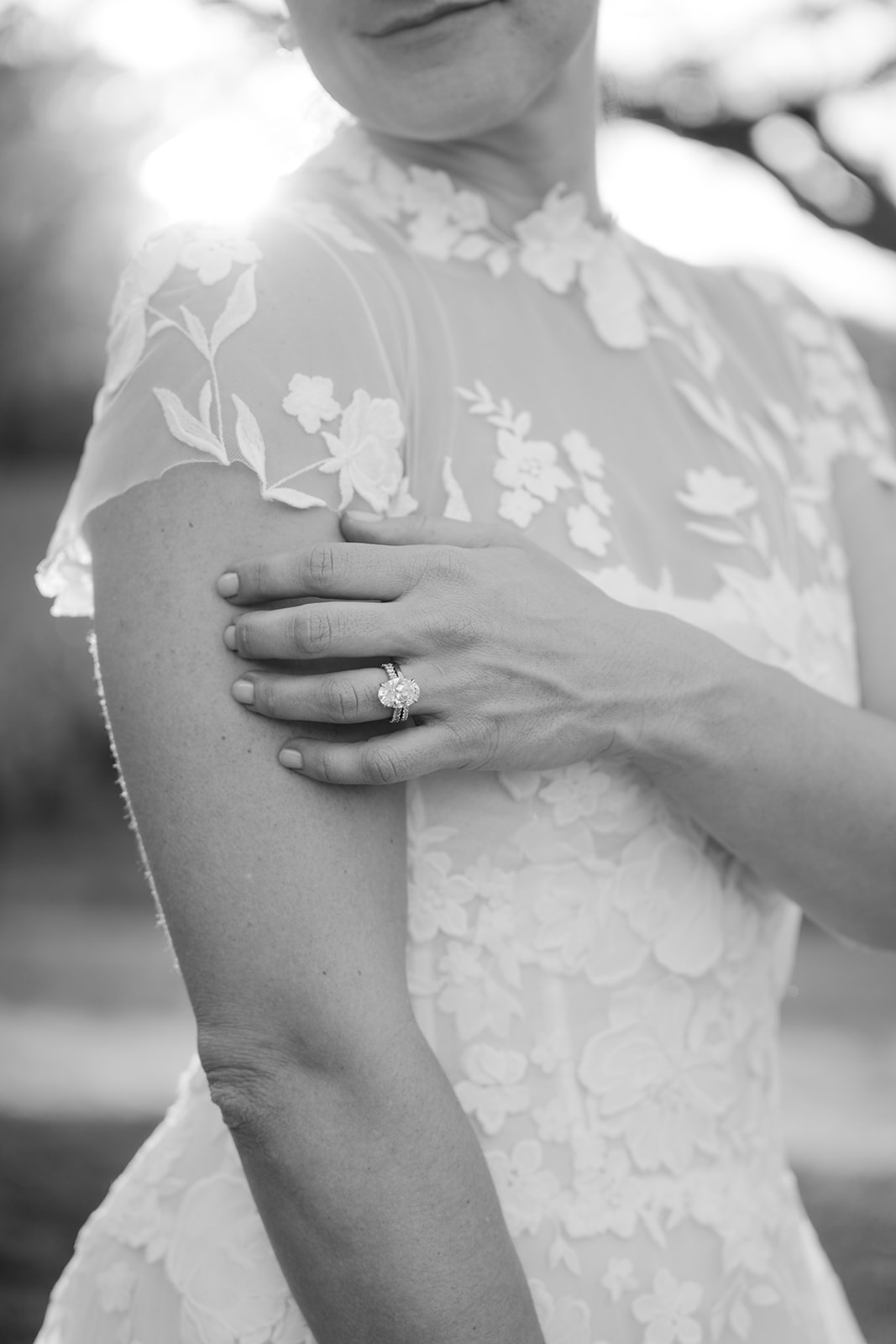 Close up details of floral-embroidered wedding gown.