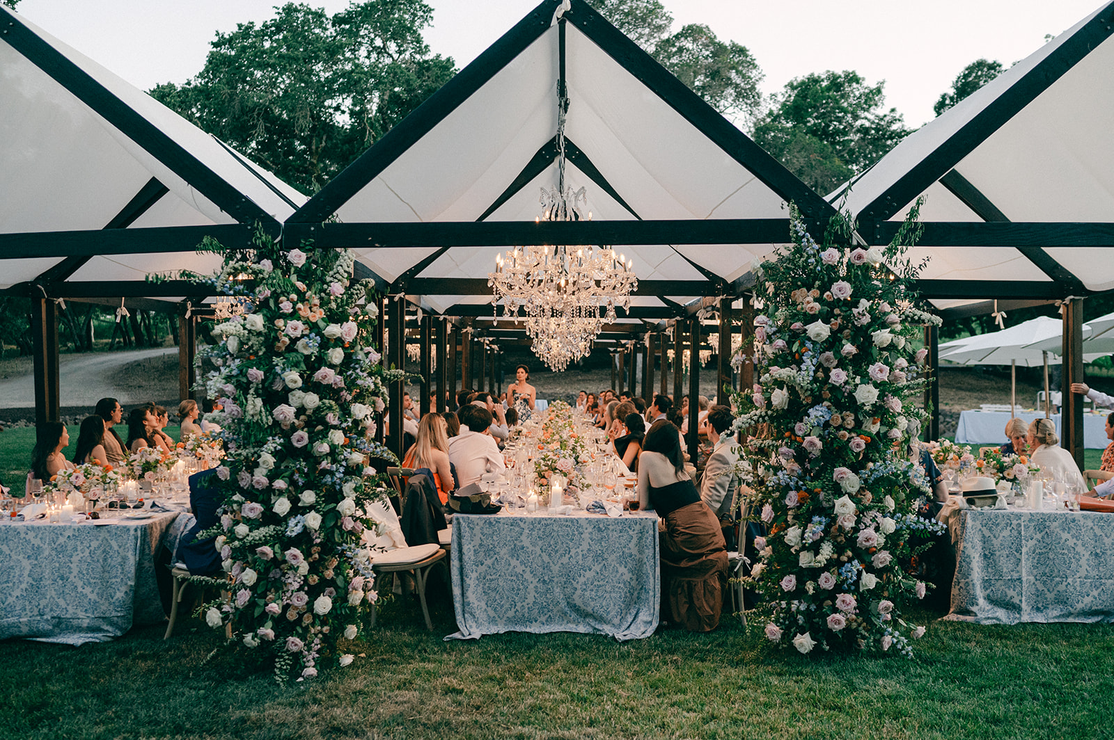 Outdoor Napa vineyard wedding reception at sunset.