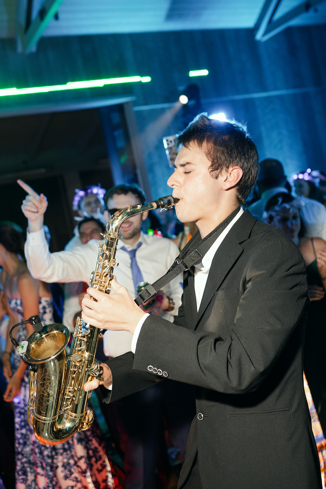 Saxophone player during high-energy wedding reception party.
