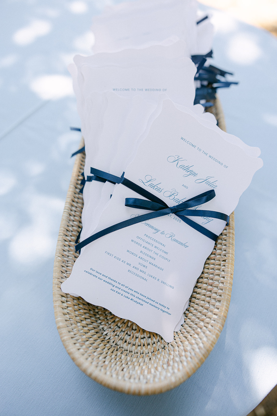 Classic wedding ceremony programs with a navy bow.