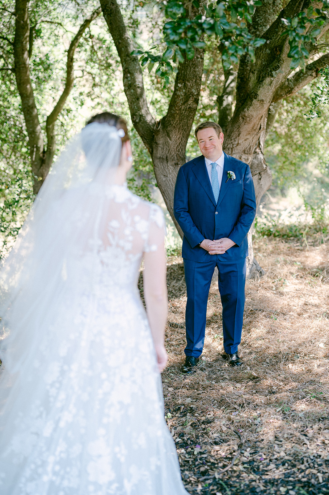 Emotional first look during a Napa vineyard wedding.