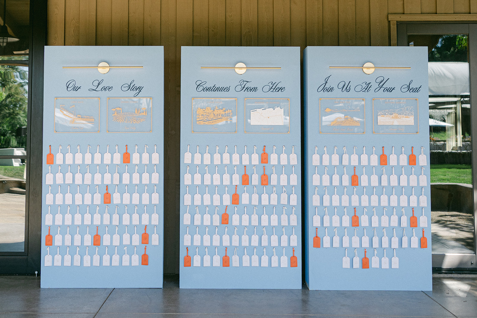 Custom luggage tag escort cards at vineyard wedding.