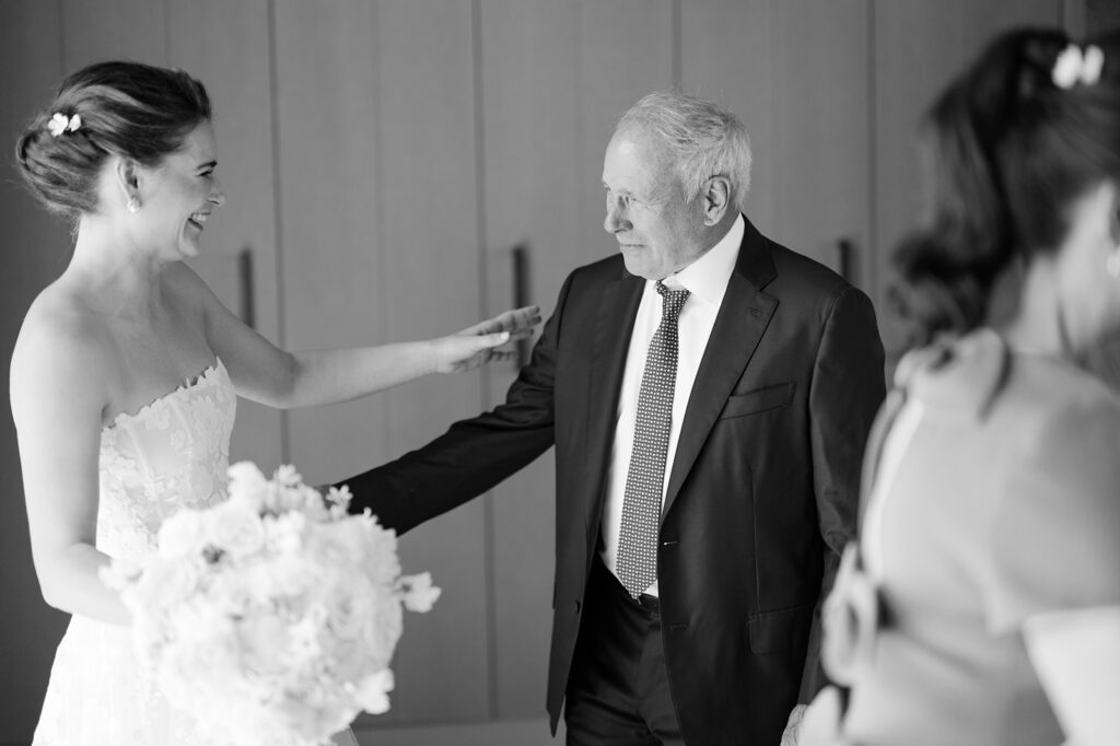 Bride surrounded by family before her Napa vineyard wedding.