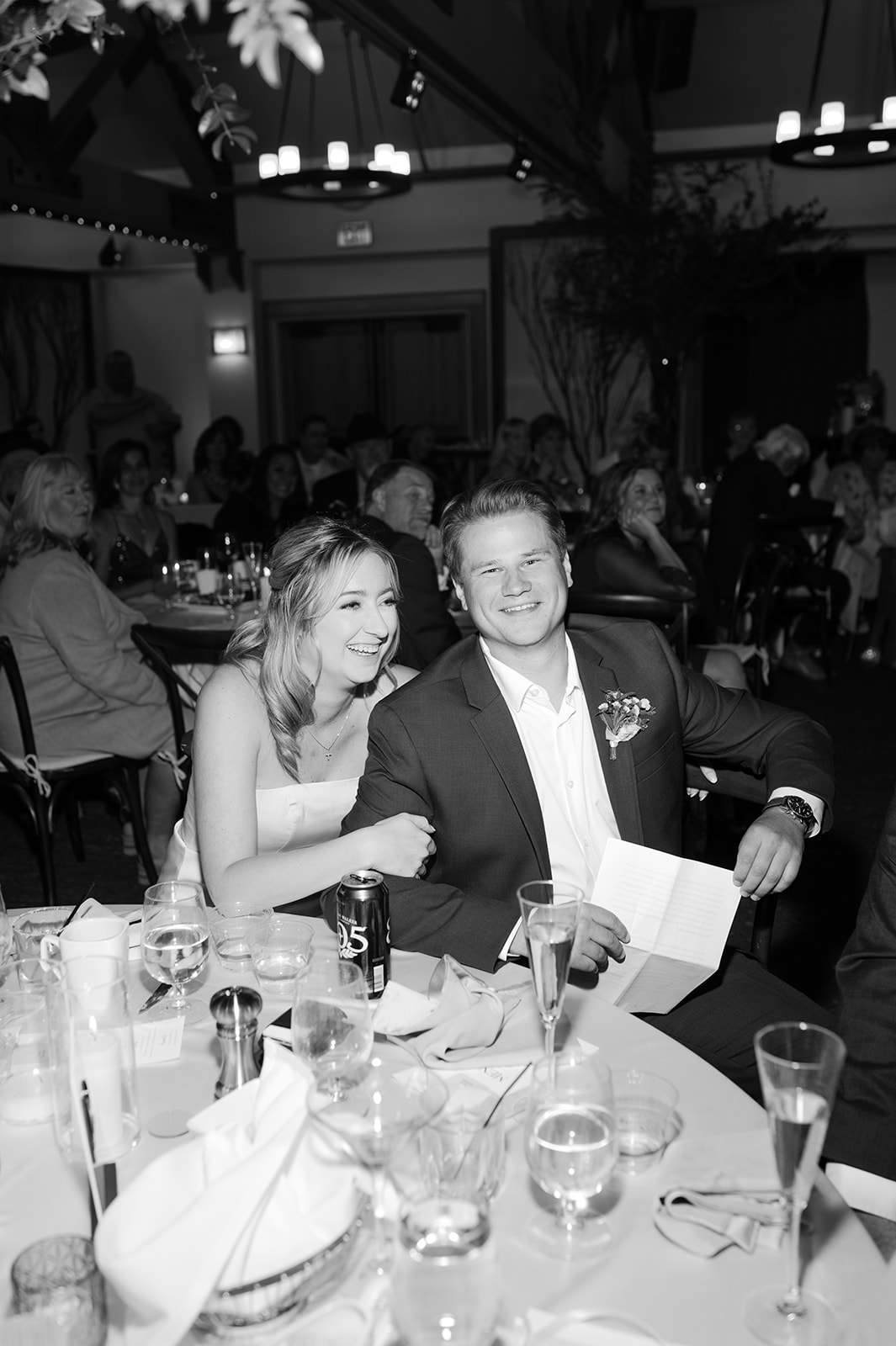 Guests laughing and mingling during speeches.