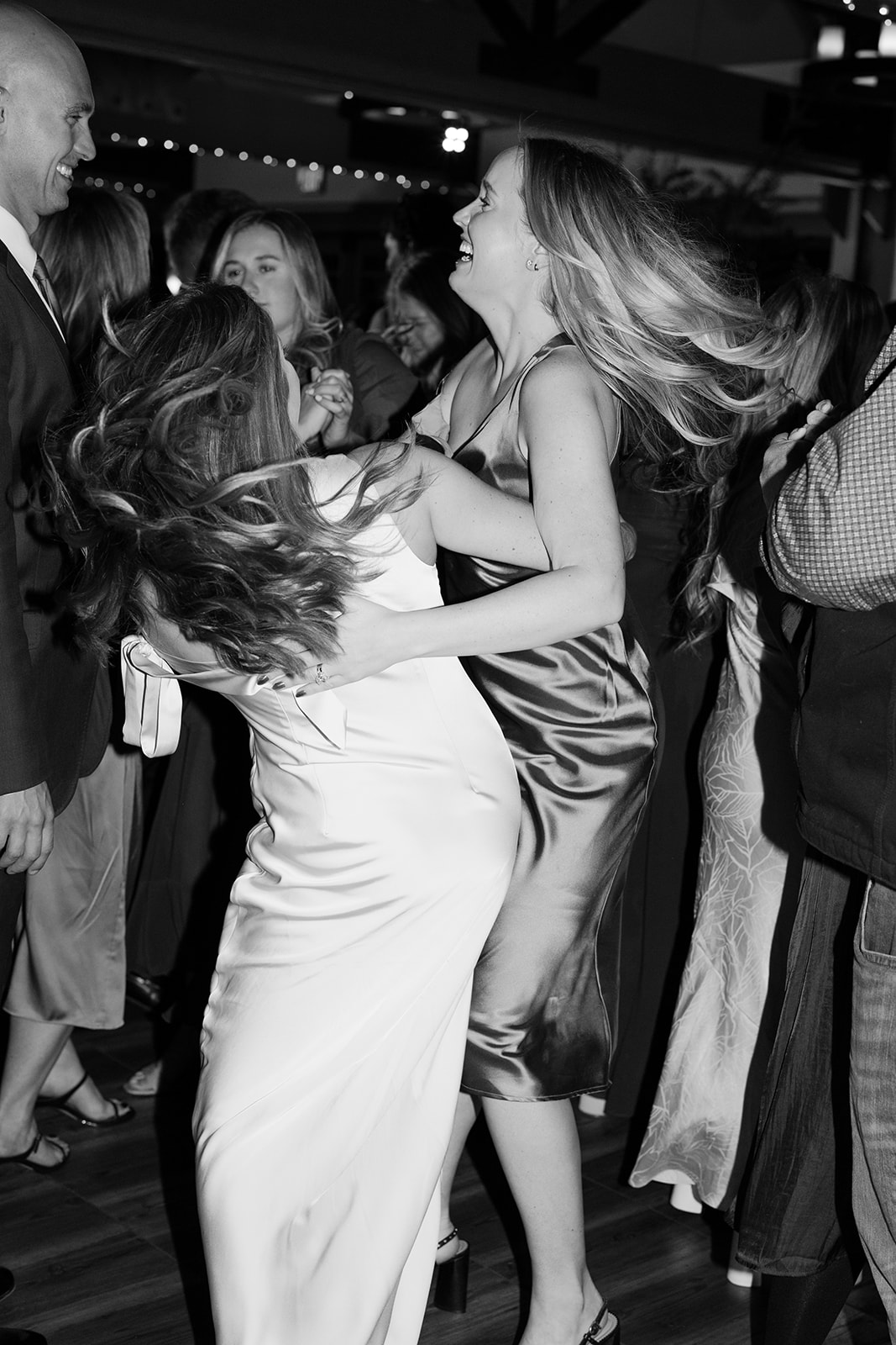 Candid moment of guests dancing at the reception.