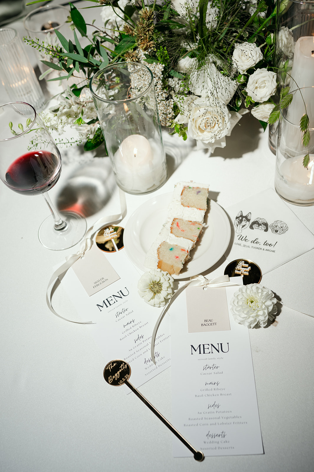 Late night flat lay of wedding reception details including menus, a slice of cake, and custom napkins.