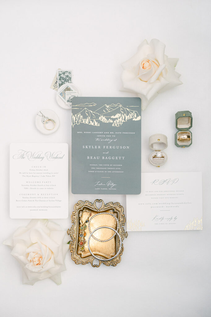 Flat lay of wedding details for a North Lake Tahoe wedding, including Skyler’s heirloom engagement ring, invitations, and florals.
