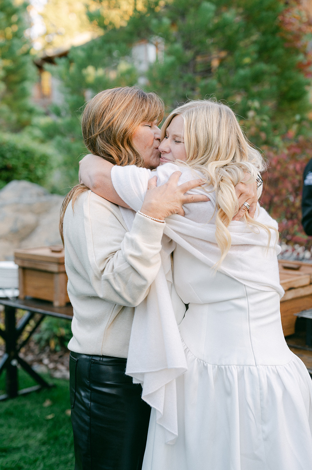 Emotional moment of the bride hugging her mom at the wedding welcome party.
