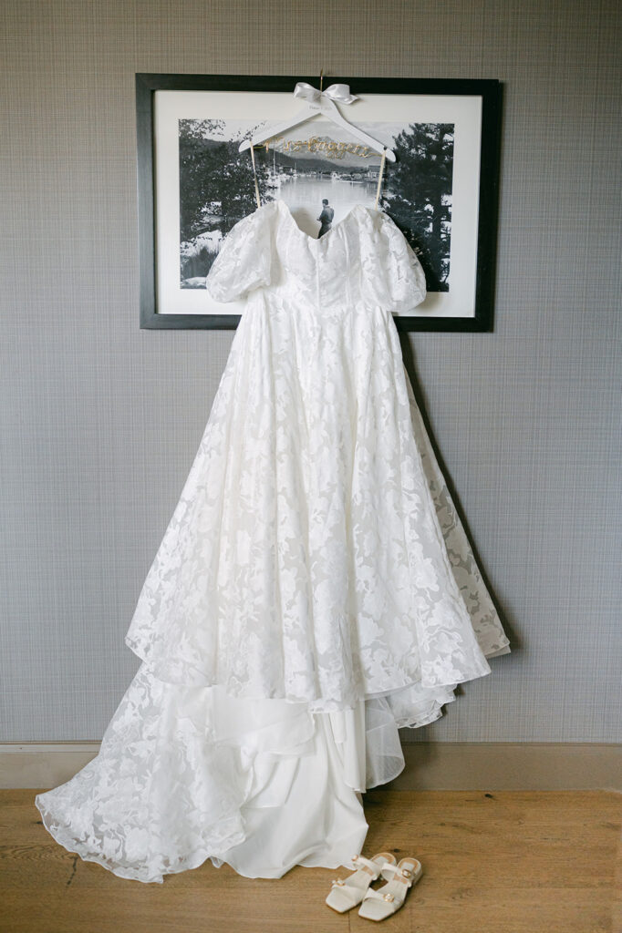 Wedding dress hanging from a photo frame in the bridal suite at The Hyatt.