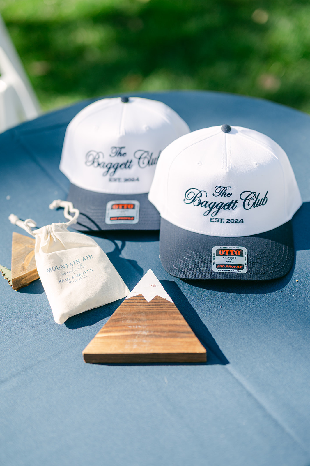 Personalized “The Baggett Club Est. 2024” hats designed as welcome gifts for the wedding weekend.