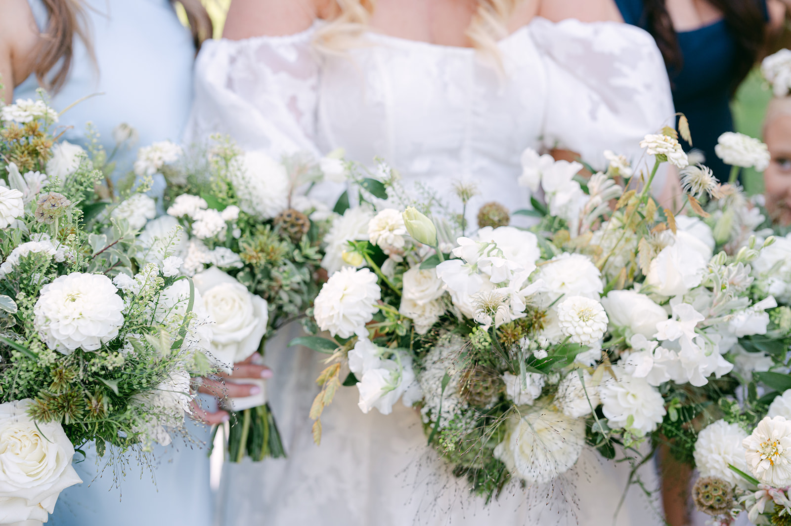 Close up of bride and bridesmaids holding bouquets.