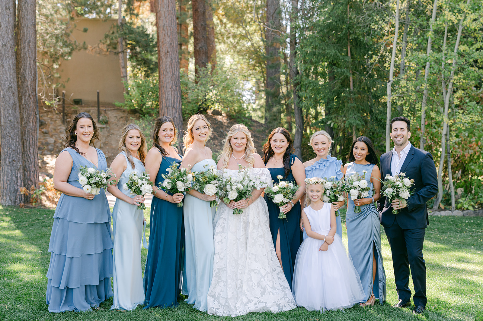 Bridal party with blue mismatched bridesmaid dresses at a North Lake Tahoe wedding.