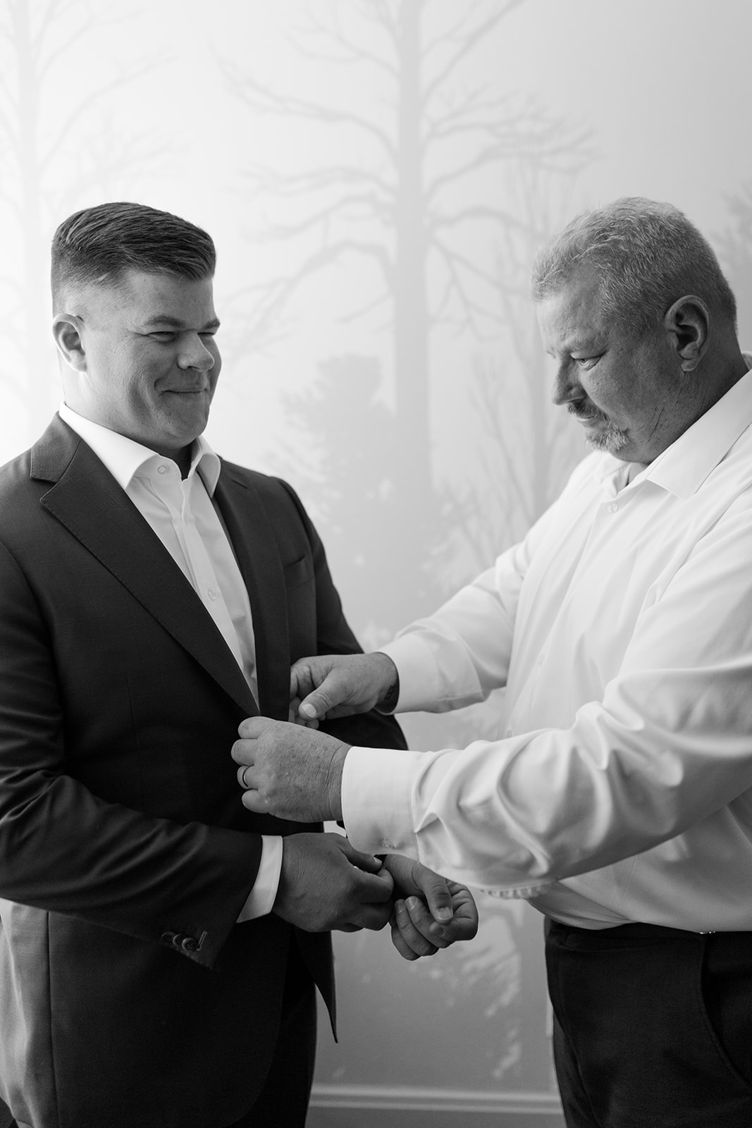 Groom getting ready with the help of his dad.