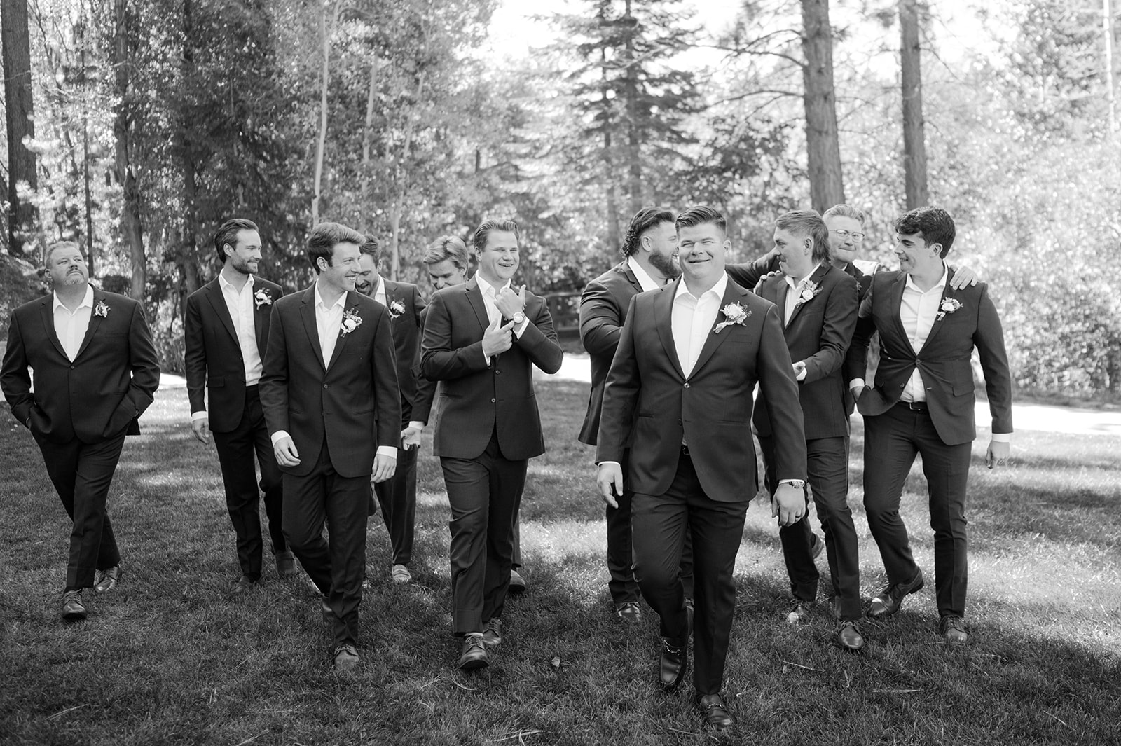 Candid moment of groom and groomsmen walking.