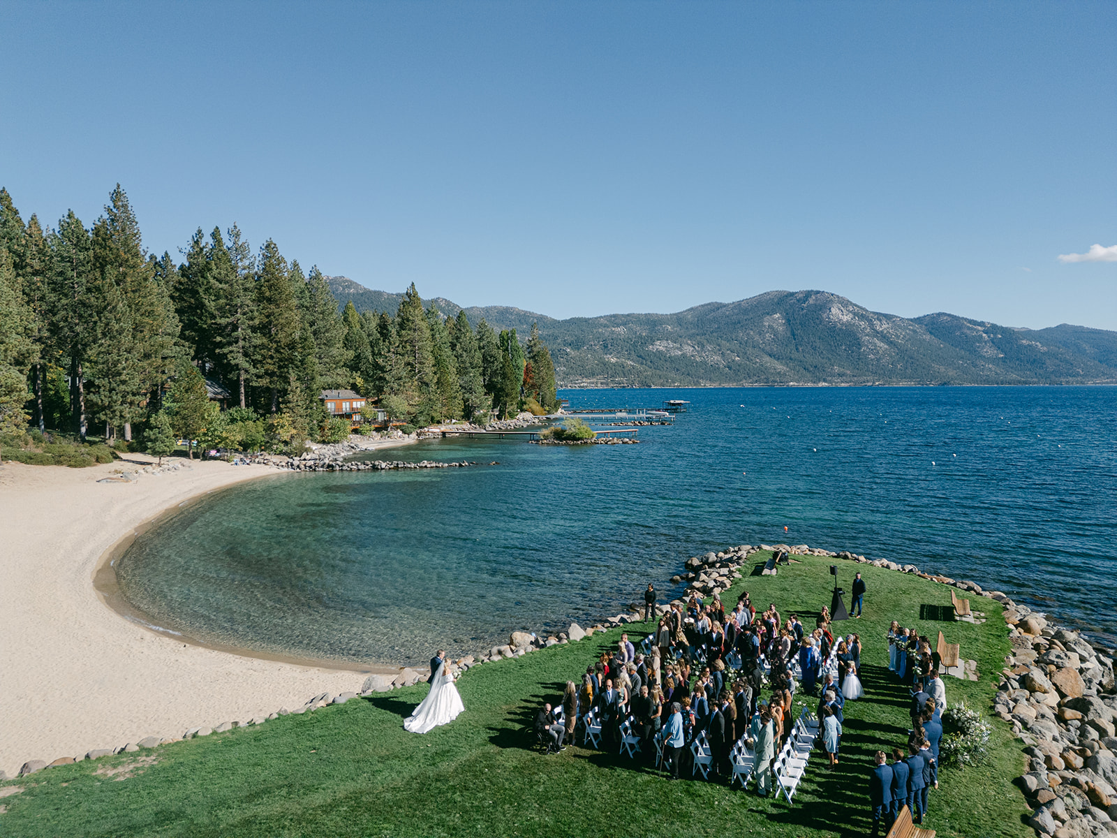 Drone shot of a Lake Tahoe private beach wedding ceremony.