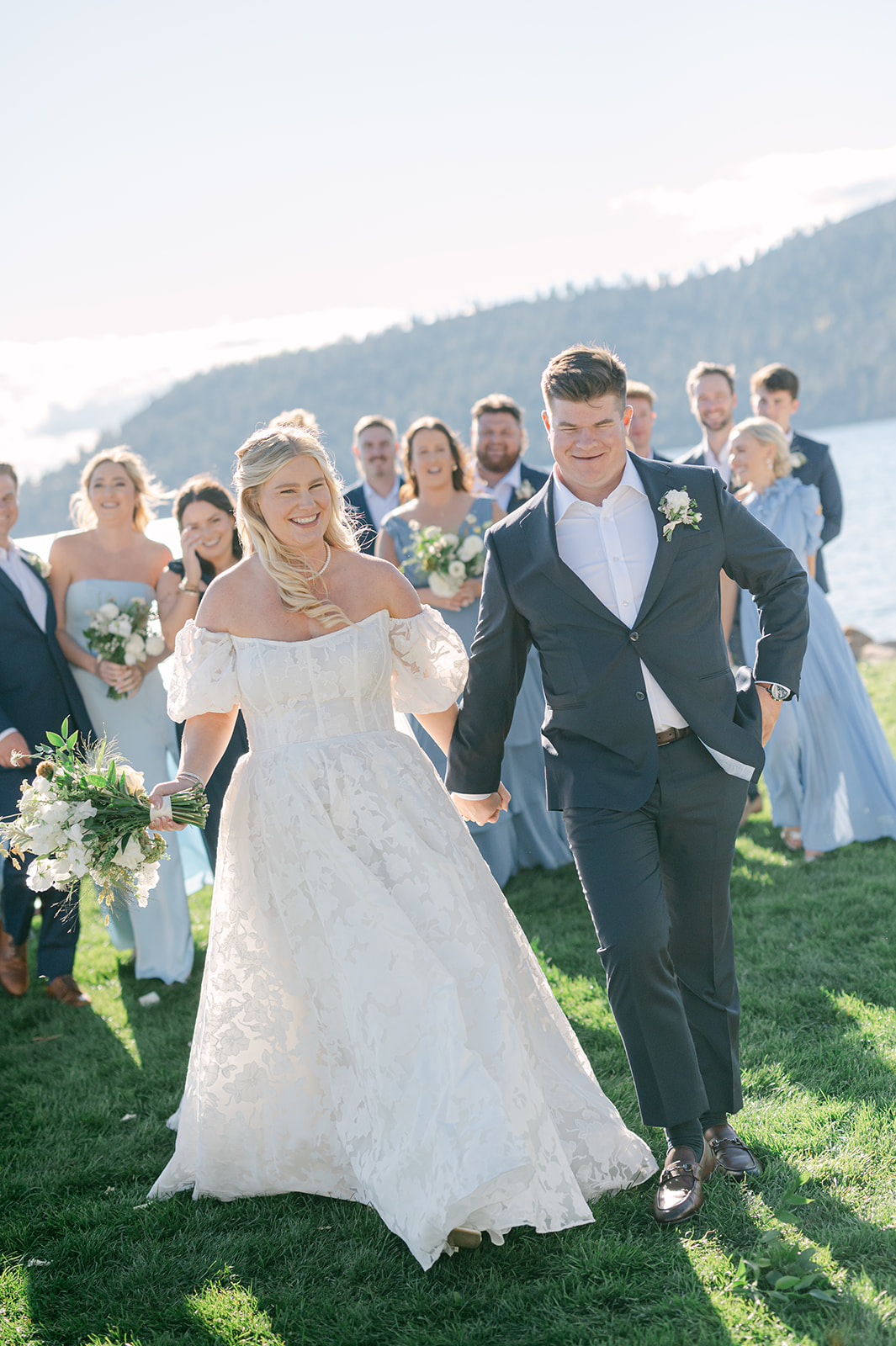 Candid photo of the bride and groom and bridal party leaving the ceremony.