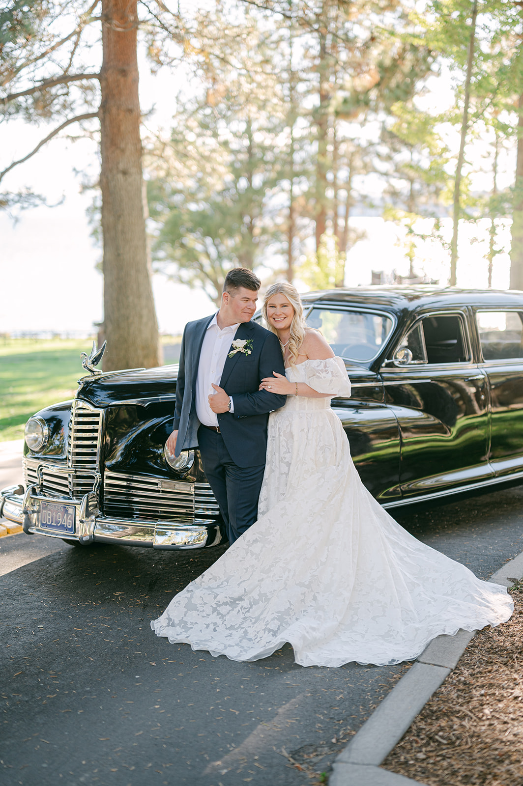 Bride and groom portraits with a vintage Packard car.