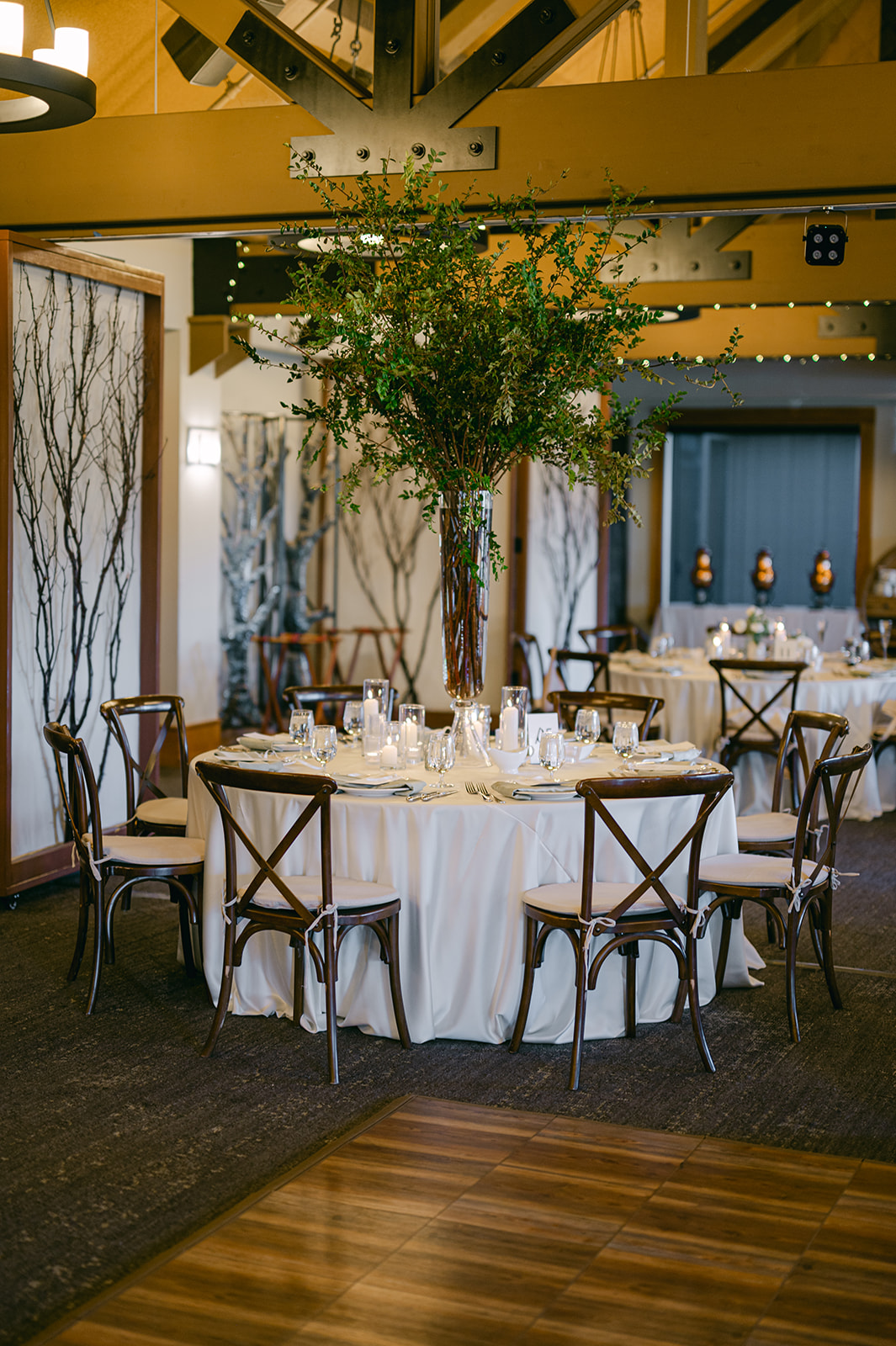 Round dinner tables with greenery and candles at The Chateau at Incline Village.