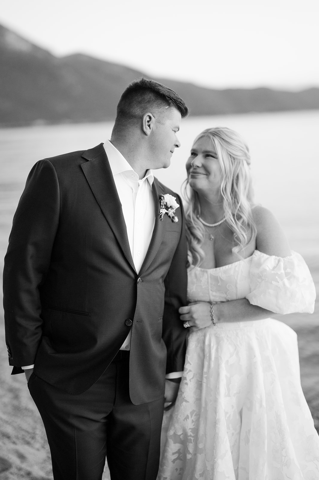Bride and groom softly smiling at each other during sunset portraits in Lake Tahoe.