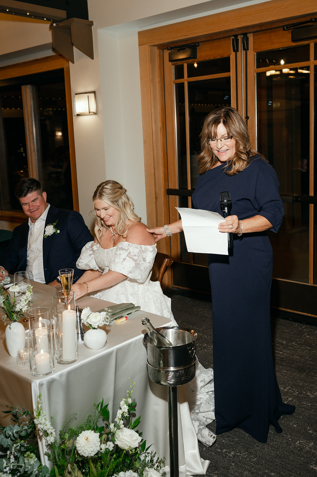 Couple listening to a speech during their reception at The Chateau at Incline Village.