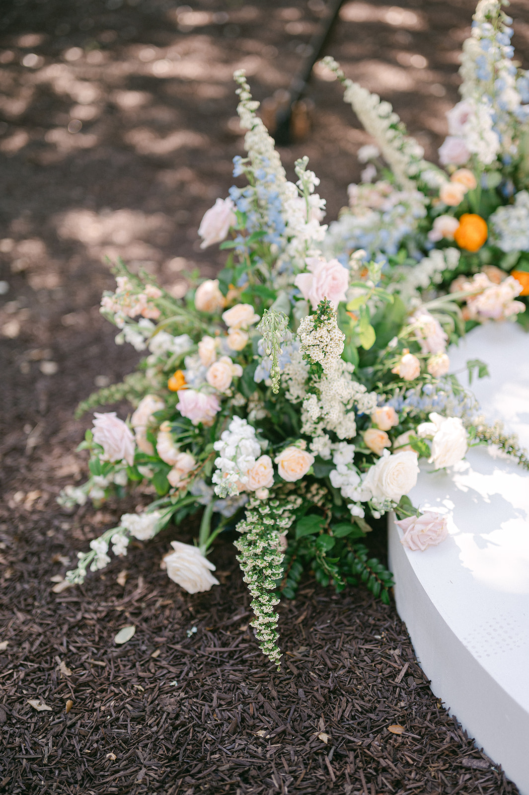Outdoor wedding ceremony florals under trees at Sonoma Vineyard Estate.