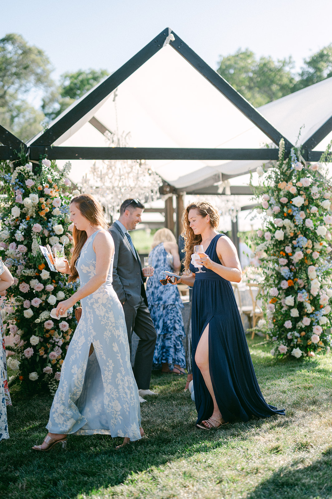 Guest portrait wearing floral dresses at an outdoor summer wedding in Napa.