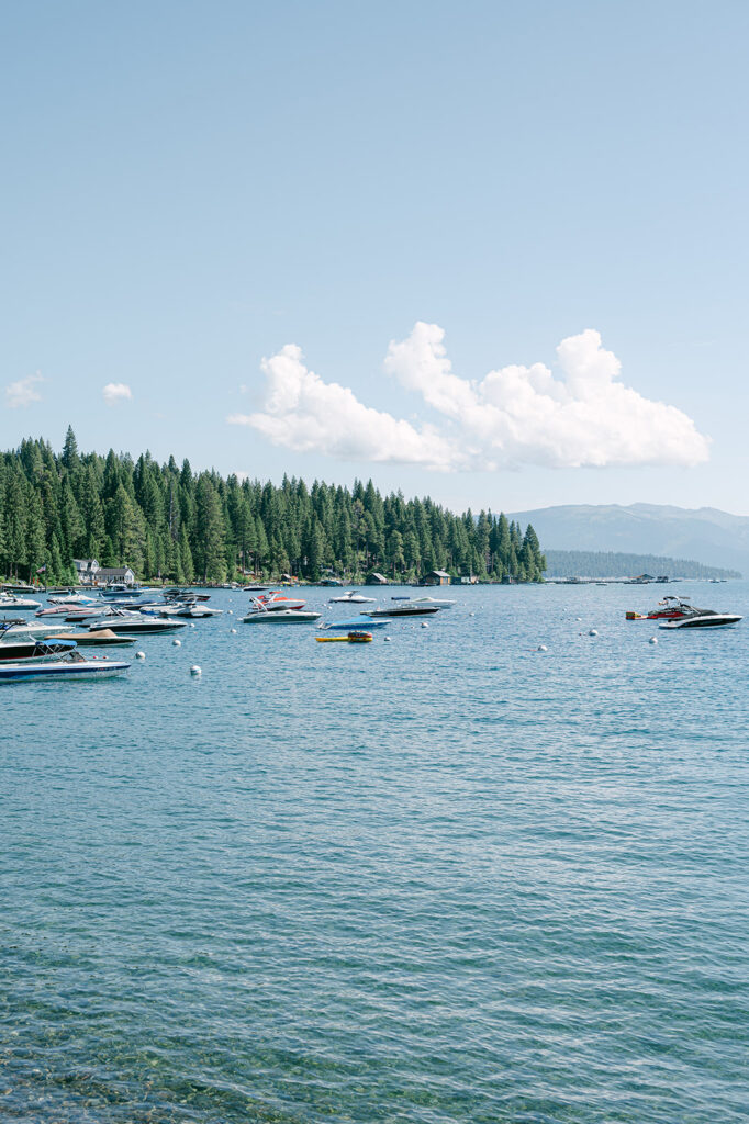 Sunny day at Lake Tahoe with many boats floating in the water.